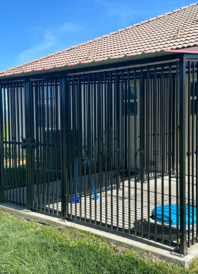 iron fence installed in backyard of residential house